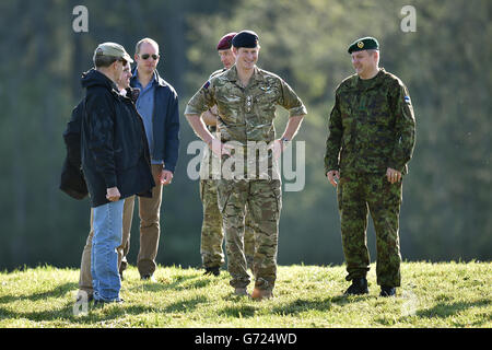 Prince Harry (centre) with President of Estonia Toomas Hendrik Ilves (left) and Chief of General Staff of the Estonian Defence Forces Major General Riho Terras (right) as he arrives at a military exercise in Sangaste on the second day of his tour to Estonia. Stock Photo