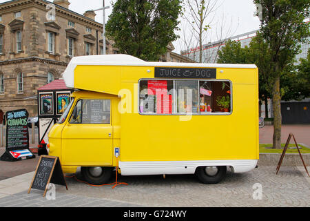 Yellow food truck of natural fruit juice and veggie food parked in the street Stock Photo