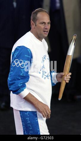 Olympic gold medallist Sir Steven Redgrave carries the Olympic torch on stage at the Olympic Torch Concert in The Mall, central London a free concert organised by Visit London and The Greater London Authority to celebrate the arrival of the Olympic torch in London. Stock Photo