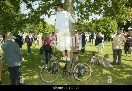 A large crowd use any vantage point to see the official opening of the Princess Diana Memorial water feature, which was officially opened by the Queen earlier this morning. Stock Photo