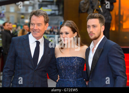 Left to right. Bryan Cranston, Elizabeth Olsen and Aaron Taylor-Johnson arriving at the European premiere of Godzilla, at the Odeon Leicester Square, central London. Stock Photo