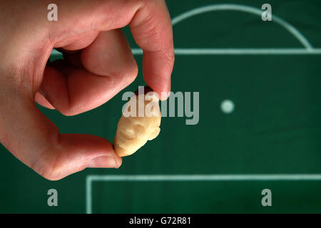 RETRANSMITTED CORRECTING TOPIC AND KEYWORD Micro-artist Quentin Devine carves a portrait of England football player Wayne Rooney out of a Brazil nut to launch television channel Dave's new programme 'England's Top 19 Footy Heroes', as part of a special World Cup series. Stock Photo