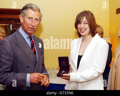 The Prince of Wales stands with his new official harpist Jemima Phillips with her 'Broach of Office' at the Great House Hotel in Laleston. Jemima Phillips, 22, follows award-winning harpist Catrin Finch, 24, who took up the post four years ago when Prince Charles reinstated the ancient royal tradition of having an Official Harpist. Miss Phillips, whose family are from Ebbw Vale in South Wales, is currently living in London, completing a course at the Royal College of Music. Stock Photo