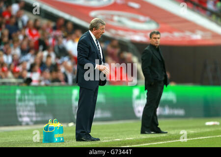 Soccer - World Cup 2014 - Friendly - England v Peru - Wembley Stadium. England manager Roy Hodgson (left) gestures instructions on the touchline Stock Photo