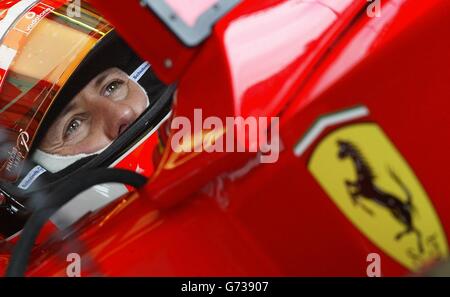 Formula one world champion Michael Schumacher watches the lap times of the other drivers from the Ferrari pits during the first practice session at Silverstone race circuit, Northamptonshire, in preparation for Sunday's British Grand Prix. Stock Photo