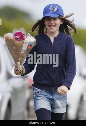 Lauren Ford with a floral tribute near the scene at Little Swinton, near Coldstream, where three people were killed after a car lost control at the Jim Clark Rally in the Scottish Borders yesterday. Stock Photo