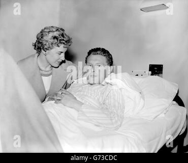 While the rest of the team celebrates at the Savoy Hotel, Nottingham Forest outside-right roy Dwight has a quiet chat with his wife, Connie, who was visiting him at Wembley General Hospital. Dwight had a broken leg after he scored the first goal in Forest's 2-1 FA Cup Final victory over Luton Town. Stock Photo