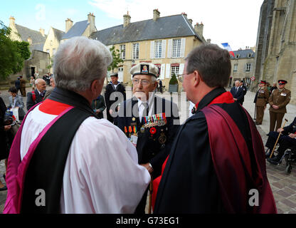 Normandy Veteran Tony Snelling, 91, talks to clergymen as he arrives at Bayeux Cathedral for a commemorative to mark 70th anniversary of the D-Day landings during World War II. Stock Photo