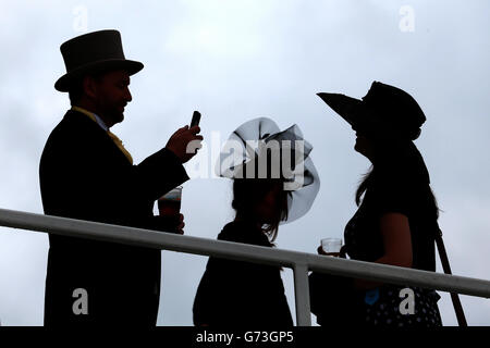 Horse Racing - Investec Derby Day 2014 - Epsom Downs Racecourse. Silhouetted racegoers during Investec Derby Day