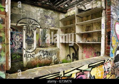 Graffiti and vandalism in abandoned derelict building. Stock Photo