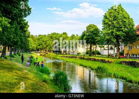 Soderkoping, Sweden - June 19, 2016: Group of people having a good time fishing and playing along the Storan river that flows th Stock Photo
