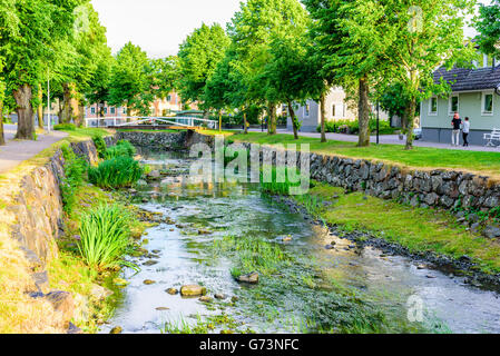 Soderkoping, Sweden - June 19, 2016: View of the river Storan that flows through town. Here in the summer evening with trees alo Stock Photo