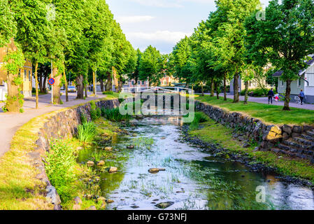 Soderkoping, Sweden - June 19, 2016: View of the river Storan that flows through town. Here in the summer evening with trees alo Stock Photo