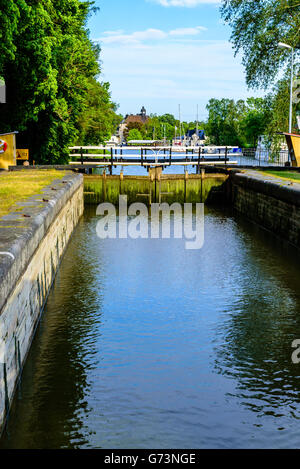 Gota canal at Soderkoping, Sweden. Closed canal lock with part of town and boats in the background. Summer evening with fine and Stock Photo