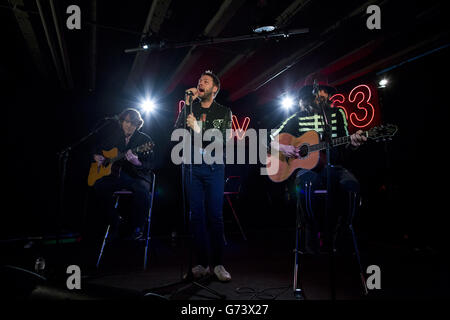 Tom Meighan (centre) of Kasabian performing at HMV in London to celebrate the release of their fifth album '48:13'. Stock Photo