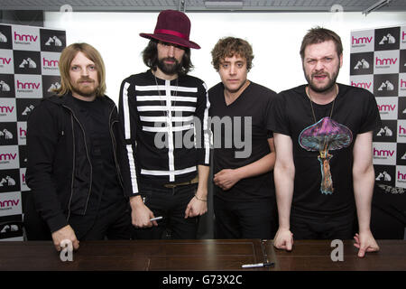 Kasabian pose for a photograph after performing at HMV in London to celebrate the release of their fifth album '48:13'. Stock Photo