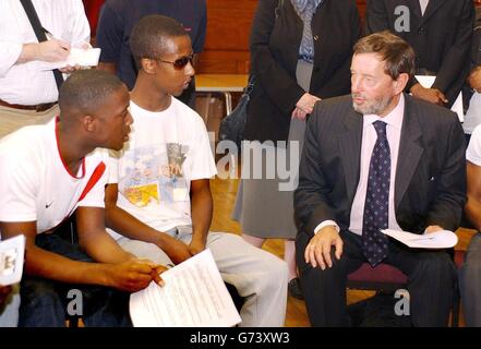 Home Secretary David Blunkett listens to Dean Millanaise (left) and rap DJ Cerose (centre), as the pair joined a large group of youngsters meeting to discuss black youth unemployment, replica weapons, and fear of crime, at the Lambeth Town Hall, in Brixton, south London Stock Photo