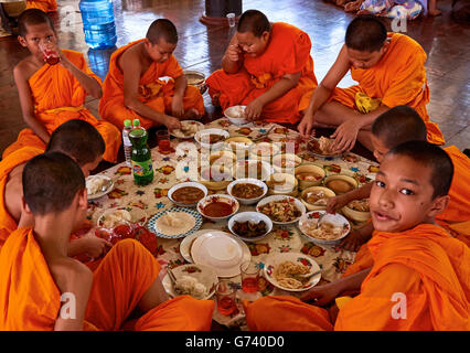 Novice monks having lunch, Phichit Thailand. Stock Photo