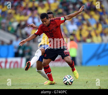 Brazil's Luiz Gustavo (left) and Mexico's Giovani dos Santos battle for the ball Stock Photo