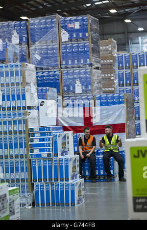 Pawel Majdek (left) and Stuart Berry, packers at Currys and PC World's distribution centre in Newark, work on delivery fulfilment as the demand for televisions, ahead of this year's summer of sport, has increased due to the retailer's Cash for Goals promotion. Stock Photo