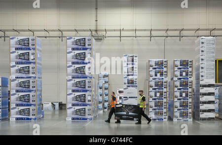 Pawel Majdek (left) and Stuart Berry, packers at Currys and PC World's distribution centre in Newark, work on delivery fulfilment as the demand for televisions, ahead of this year's summer of sport, has increased due to the retailer's Cash for Goals promotion. Stock Photo