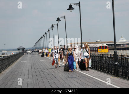 Isle of Wight Festival 2014 - Day 1. Festival goers walking along Ryde pier, Isle of Wight as they arrive for the Isle of Wight Festival. Stock Photo