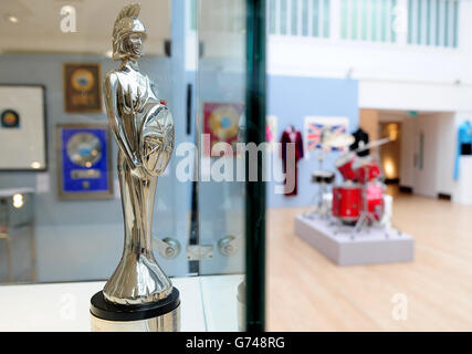 A Brit Award, won by Oasis for What's The Story Morning Glory, est &pound;4000-6000, and the drum kit used by Tony McCarroll used on the bands first album Definitely Maybe, est &pound;1200-15000, at a preview for the Pop Culture auction at Bonhams in London. Stock Photo
