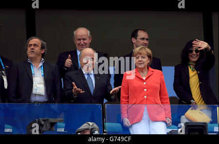 UEFA president Michel Platini (left), FIFA president Sepp Blatter (second left) and German Chancellor Angela Merkel (second right) in the stands Stock Photo