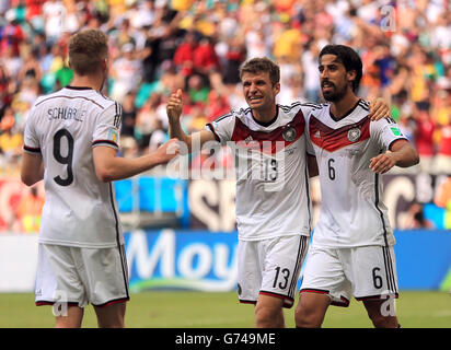 Germany's Thomas Muller celebrates scoring his side's fourth goal of the game to complete his hat-trick with Andre Schurrle and Sami Khedira (right) Stock Photo