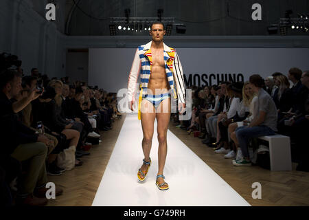 A model appears on the catwalk during the Moschino show on day two of London Collections Men, London. Stock Photo