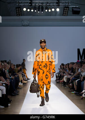 A model appears on the catwalk during the Moschino show on day two of London Collections Men, London. Stock Photo