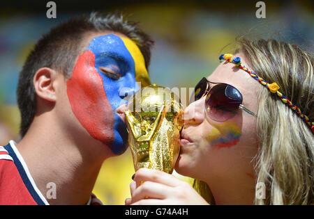 Soccer - FIFA World Cup 2014 - Group C - Colombia v Ivory Coast - Estadio Nacional. Columbia fans kiss a replica world cup trophy before kick off Stock Photo