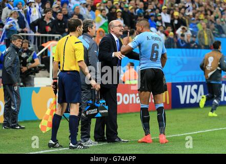 Uruguay's Alvaro Pereira (right) reacts after coming round from a head injury following a coming together with England's Raheem Sterling during the Group D match the Estadio do Sao Paulo, Sao Paulo, Brazil. Stock Photo