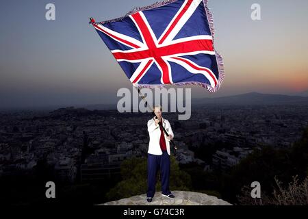 British Judo competitor Kate Howey from Andover, Hampshire, holds the British flag aloft in Athens, Greece. Kate will carry the flag and lead the team during Friday evening's opening ceremony for the 2004 Olympic Games. Stock Photo