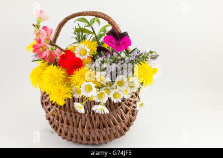 Flower basket made of wicker against white background Stock Photo