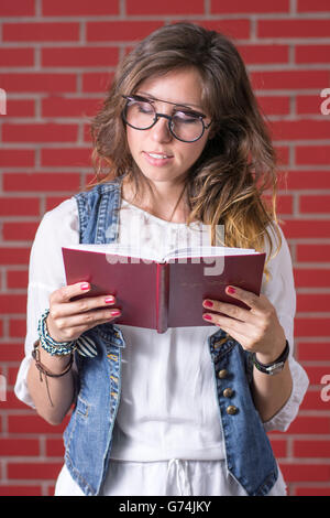 Woman reading a book with double eyesight glasses Stock Photo