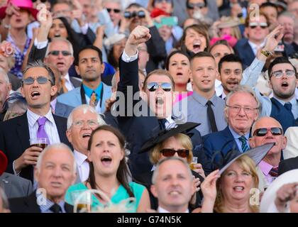 A racegoer cheers as he watches the St James's Palace Stakes through binoculars during Day One of the 2014 Royal Ascot Meeting at Ascot Racecourse, Berkshire. Stock Photo