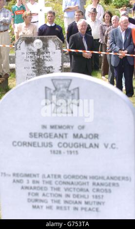 Members of the public pay their respects, after Irish Minister for Defence, Michael Smith, unveiled a headstone dedicated to Sergeant Major Cornelius Coughlan in Aghavale Cemetery, Westport, Co Mayo. Sgt Maj Coughlan was awarded the Victoria Cross for bringing a severely wounded soldier to safety under fire. He led his men in attack during the siege of Delhi, resulting in victory when the Kabul Gate was taken. Stock Photo