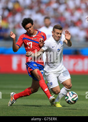 Costa Rica's Yeltsin Tejeda (left) and Jack Wilshere battle for the ball during the FIFA World Cup, Group D match at the Estadio Mineirao, Belo Horizonte, Brazil. Stock Photo