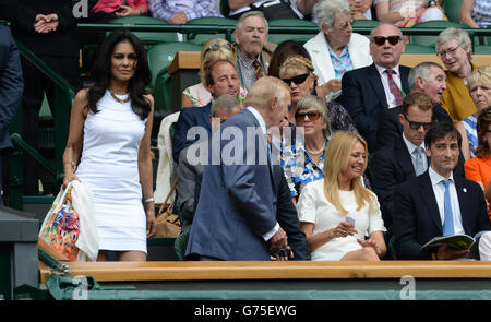 Tennis - 2014 Wimbledon Championships - Day Two - The All England Lawn Tennis and Croquet Club. Sir Bruce and Wilnelia Forsyth take their seats in the Royal Box, near Tess Daly and Alistair McGowan Stock Photo