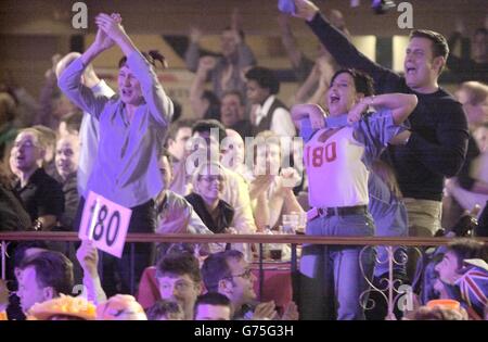 Jubilant spectators celebrate a 180 score during the semi-final match ofthe Embassy World Darts Championships between Colin Monk and Mervyn King at the Lakeside Country Club, Frimley Green, Surrey. Stock Photo