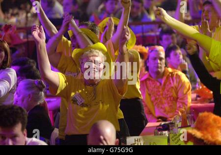 Jubilant spectators celebrate a 180 score during the semi-final match of the Embassy World Darts Championships between Colin Monk and Mervyn King at the Lakeside Country Club, Frimley Green, Surrey. Stock Photo