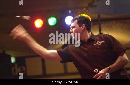 Tony David from Australia playing against Martin Adams during their semi-final match in the Embassy World Darts Championships at the Lakeside Country Club, Frimley Green Surrey. Stock Photo