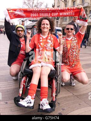 Liverpool FC fans (L-R) Ali Hamadi, Anne-Marie Barton and Chris Burns in their club colours on the Rambla Catalunya in Barcelona, Spain ahead of his sides UEFA Champions League group B match against Barcelona. Stock Photo