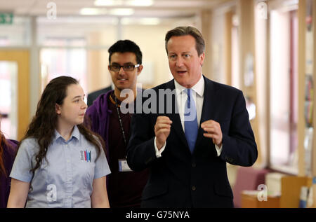 Prime Minister David Cameron is shown around Halesowen College by student Amy Dudfield during his visit to the West Midlands.