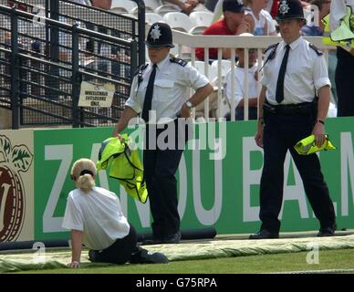 Police officers patrol the outfield during the final day of the first npower test between England and India at Lord's, London 2002. Security has been stepped up at the ground today after a fan walked next to Sachin Tendulkar on the field yesterday. Stock Photo