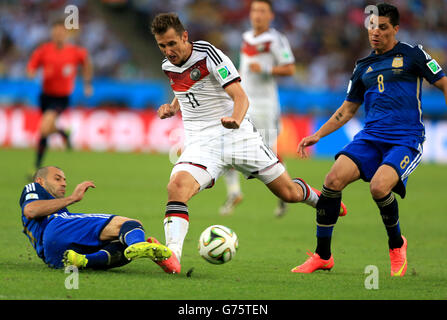 Argentina's Javier Mascherano slides in on Germany's Miroslav Klose during the FIFA World Cup Final at the Estadio do Maracana, Rio de Janerio, Brazil. Stock Photo