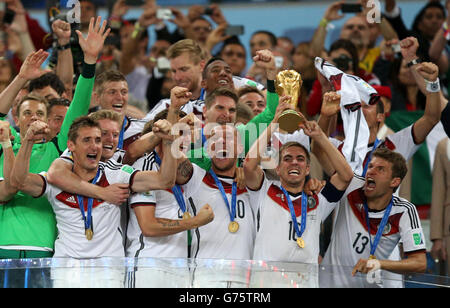 Germany captain Philipp Lahm lifts the FIFA World Cup trophy with team-mates after the FIFA World Cup Final at the Estadio do Maracana, Rio de Janerio, Brazil. Stock Photo