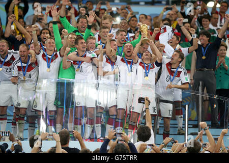 RIO DE JANEIRO, BRAZIL - JULY 13: Philipp Lahm of Germany lifts the World  Cup trophy to celebrate with his team…