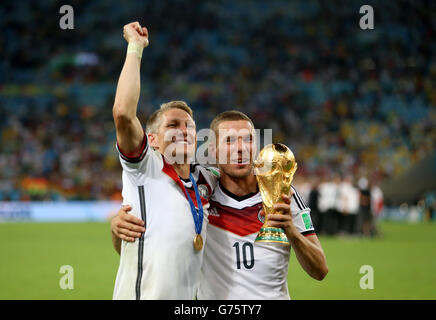 Germany's Bastian Schweinsteiger (left) and Lukas Podolski celebrate winning the World Cup after the FIFA World Cup Final at the Estadio do Maracana, Rio de Janerio, Brazil. Stock Photo